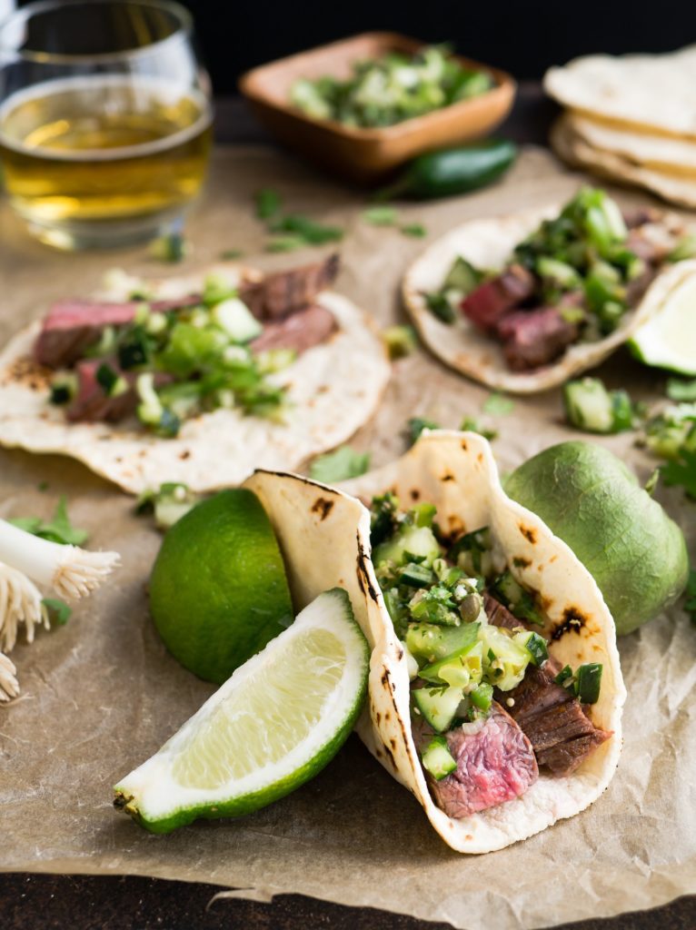 closeup of tacos with lime wedges and cilantro, a great pairing for riesling wines