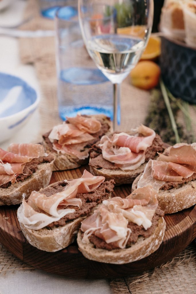 glass of Viognier white wine with charcuterie meats and bread